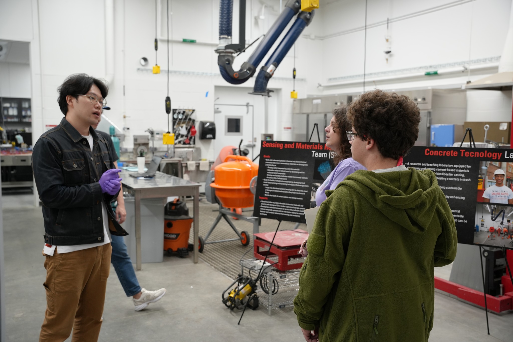 An image from a manufacturing lab at a university, with people talking in the large room